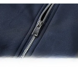 Close-up of premium silver metal zipper on navy heavy knit men's jacket with clean stitching