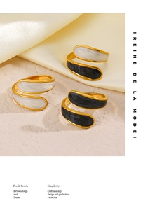 Detail view of 18K gold plated spiral rings with black and white enamel finish