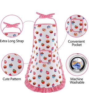 Detail view of a white cupcake apron with pink polka dot ruffles and long straps