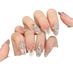 Sparkly pink press-on nails with Christmas rhinestones and star accents for women