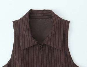 Detail shot of brown pinstripe vest showing collar texture and zip closure design