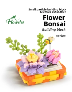 Close-up of DIY flower bonsai building blocks with pink lilies and a small bee