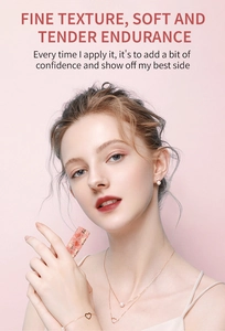 Close-up of matte moisturizing lipstick with heart-patterned peach pink case on a model