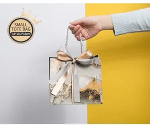 Detailed macro view of small marble gift bag with elegant ribbon and 18x10.2x16cm dimensions