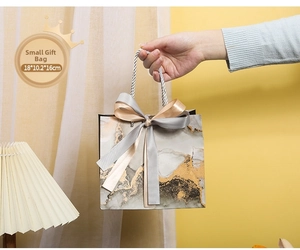 Detailed macro view of small marble gift bag with elegant ribbon and 18x10.2x16cm dimensions