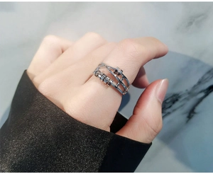 Close-up of silver anti-anxiety spinning ring with movable beads on a finger