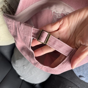 Pink dog embroidery baseball cap featuring an adjustable bronze metal back buckle