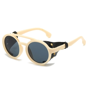 Retro steampunk sunglasses with cream frames, dark round lenses, and side leather shields