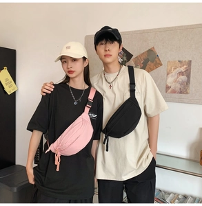 Fashionable unisex canvas chest bags in pink and black shown on male and female models