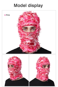 Detailed close-up showing pink and white fringe texture of knit balaclava mask