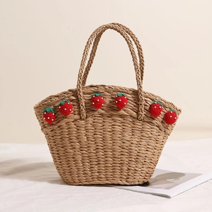 Handwoven straw tote bag with red strawberry accents and a large capacity beach design