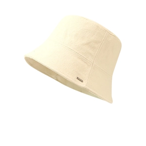 Beige bucket hat with twill texture and small metal logo on a clean white background