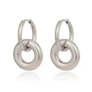 Detailed macro view of silver-toned double interlocking hoop earrings on white background