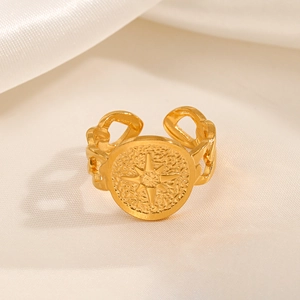Gold eight-pointed star compass ring with Cuban chain band on elegant white satin fabric