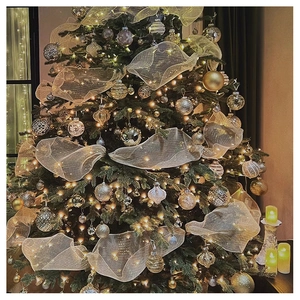 Close-up of champagne gold mesh ribbon with metallic stripes decorating a Christmas tree