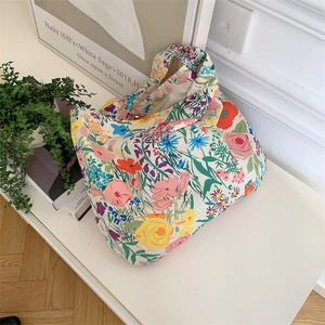 Detailed overhead shot of a large floral canvas tote bag with multi-colored flower prints