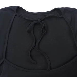 Close-up detail of the elegant back lace-up tie design on a black long-sleeved top