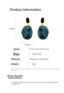 Detail view of 5.8x2.7cm resin earrings with peacock pattern and 925 silver needles