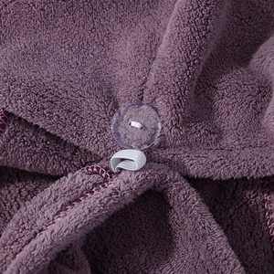 Detail of deep purple coral fleece hair towel with transparent button and elastic loop