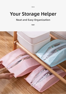 Detail of waterproof shoe storage bags with clear windows and zipper closure on wood rack