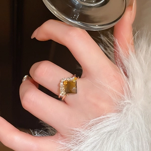 Detail of snake-style open ring with square tiger eye stone and zircon in rose gold