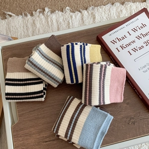 Five pairs of Korean-style striped cotton mid-calf socks displayed on a wooden tray