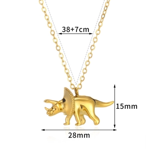 Detailed view of golden dinosaur pendant with specific chain and size measurements