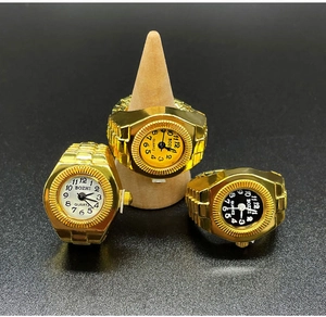 Detailed macro view of three gold quartz ring watches with white, black and yellow dials