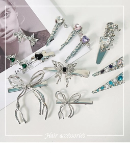Detailed close-up of mixed silver metal hair clips with multi-color crystals and pearls