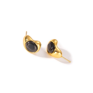 Macro shot of French style irregular waterdrop stud earrings with black cat-eye stone
