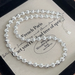 Detailed close-up of S925 sterling silver bead necklace with heart charm and lobster clasp