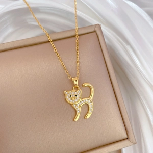 Detailed view of a gold cat pendant with sparkling rhinestones in a jewelry box