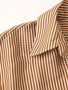 Detailed close-up of brown and white vertical striped tencel shirt dress collar and fabric