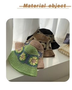 Detail of hand-crocheted bucket hats with floral patterns in green pink brown and black