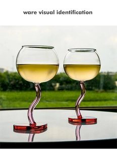 Close-up of heart-shaped wine glasses with purple S-curved stems and red bases