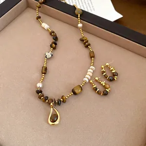 Tiger eye beaded necklace and earring set with golden pendants in a gift box