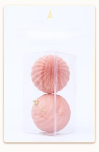 Detailed view of pink flocked Christmas ornaments with vertical stripe texture in box