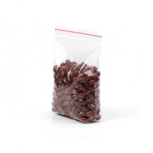 Detail view of a clear PE ziplock bag with red sealing strip containing red beans
