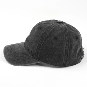 Detail view of washed dark grey cotton canvas baseball cap with vintage distressed texture