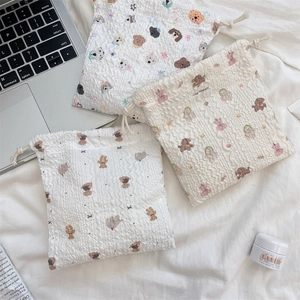 Detail of cartoon drawstring storage bags with textured bubble fabric and cute animal prints
