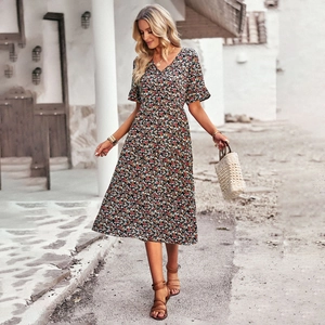Chic floral V-neck midi dress with short sleeves for women walking in a scenic street