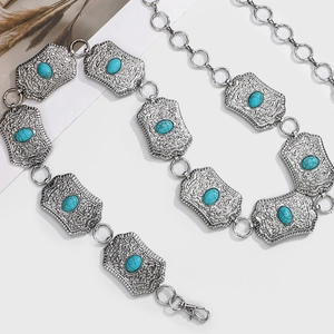 Detail of silver bohemian chain belt with turquoise stones and engraved rectangular links