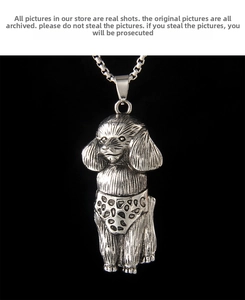 Close-up of vintage silver poodle pendant showing detailed fur texture and design