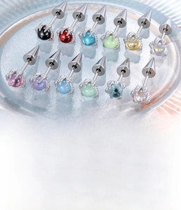 Detail view of colorful zircon dragon claw piercing studs made of stainless steel