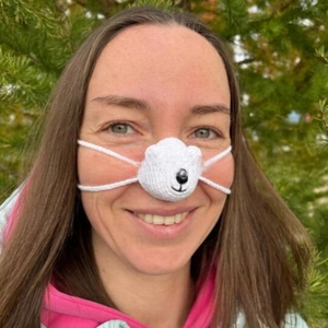 Close-up of handmade white polar bear crochet nose warmer with elastic ear loops