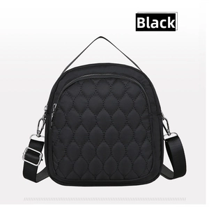 Close-up of black waterproof nylon bag featuring unique leaf-shaped quilting and silver zippers