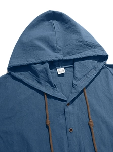 Close-up of dark blue cotton hoodie shirt showing button placket and collar label detail