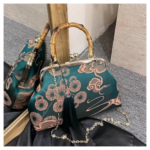 Detail der Tasche im chinesischen Stil mit Bambusgriff und grüner Quasten-Anhänger