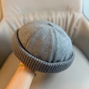 Close-up of a grey knitted docker hat with thick folded brim and soft texture