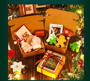 Detailed overhead view of Christmas tree and gingerbread man scented candle gift set with wood base